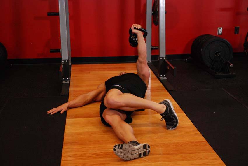 Extended Range One-Arm Kettlebell Floor Press — end position